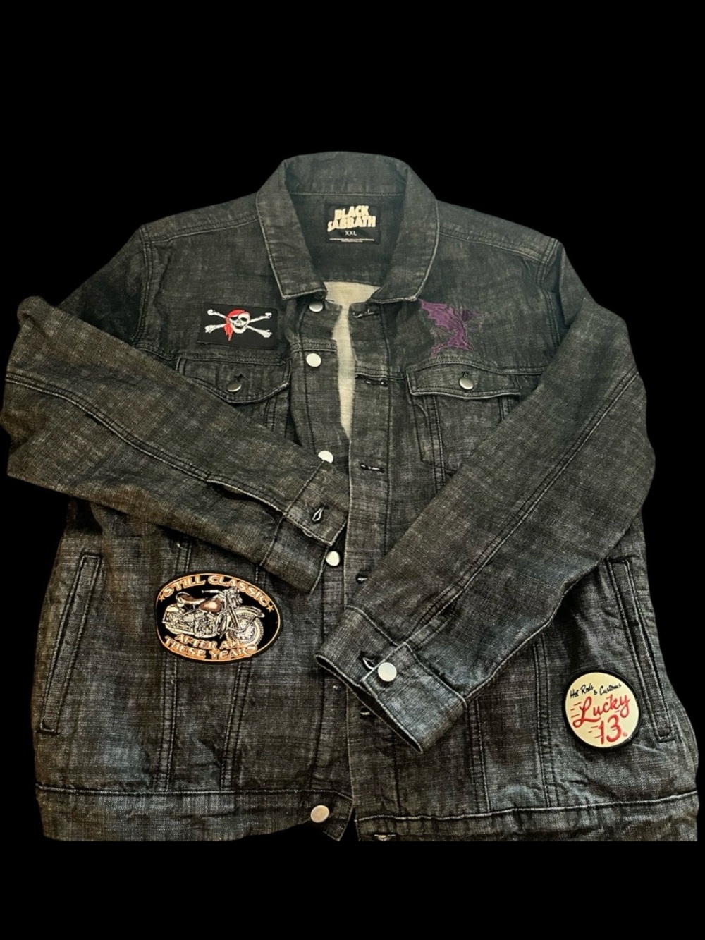 Denim trucker style dark denim jean jacket featuring graphics from the “Paranoid